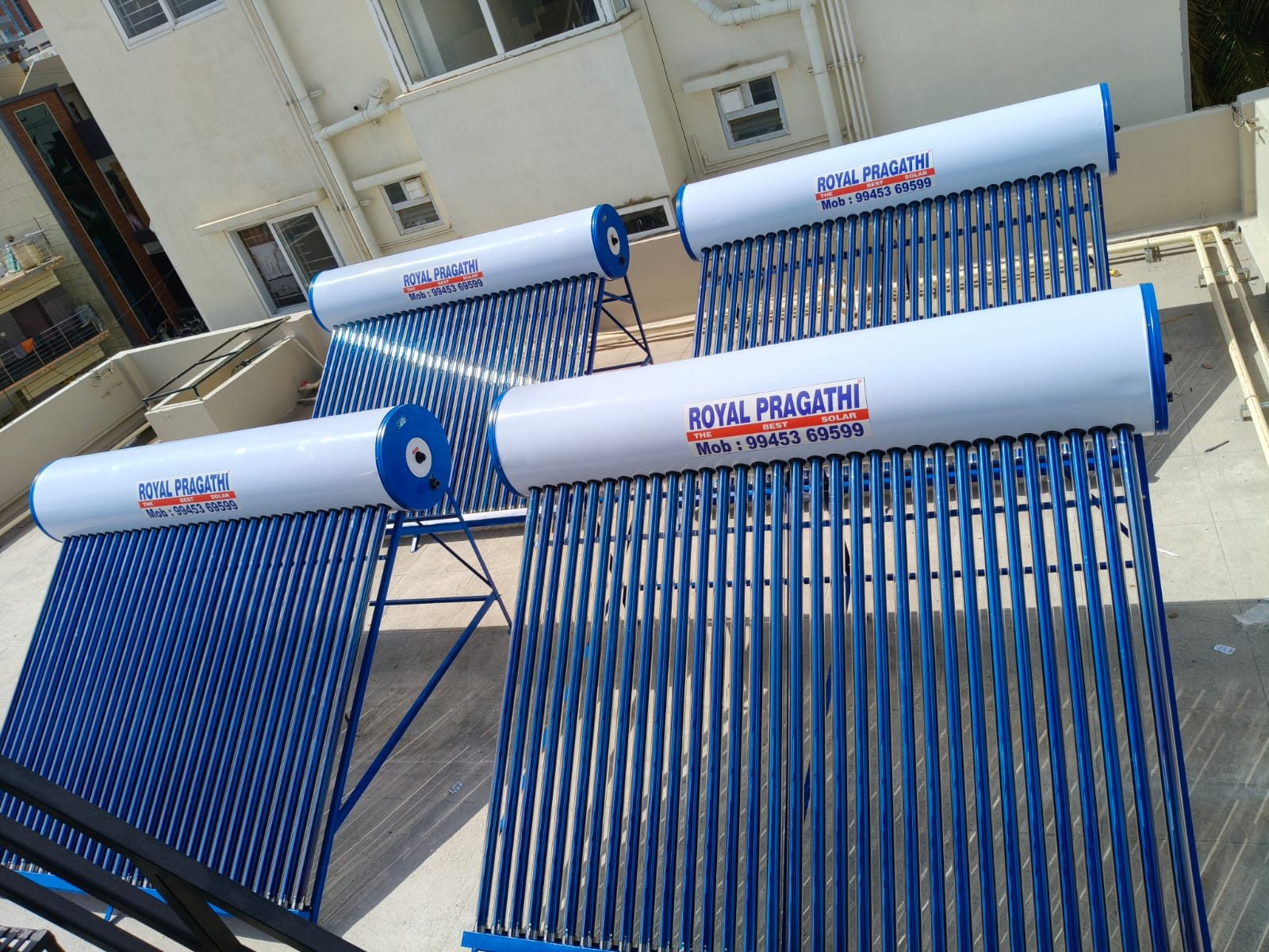 Four ROYAL PRAGATI ETC solar water heaters installed on a rooftop